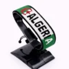 Handcrafted Algeria name flag bracelet made with green, white, and red beads, featuring a custom name, adjustable beaded wrist accessory, displayed on a black stand.
