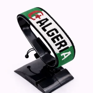 Handcrafted Algeria name flag bracelet made with green, white, and red beads, featuring a custom name, adjustable beaded wrist accessory, displayed on a black stand.