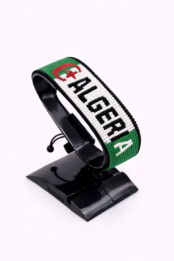 Handcrafted Algeria name flag bracelet made with green, white, and red beads, featuring a custom name, adjustable beaded wrist accessory, displayed on a black stand.