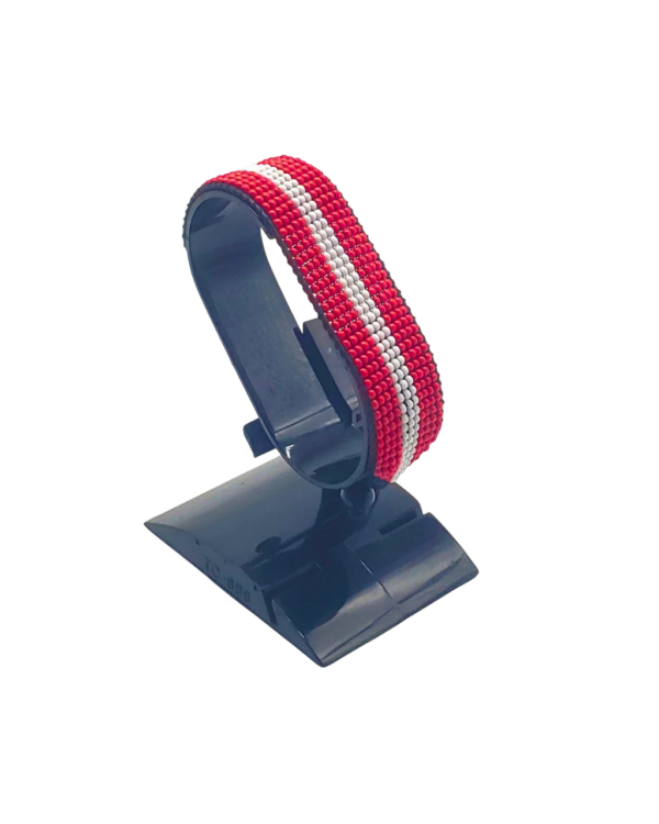 Handcrafted Austria flag bracelet made with red and white beads, featuring a adjustable beaded wrist accessory, displayed on a black stand.