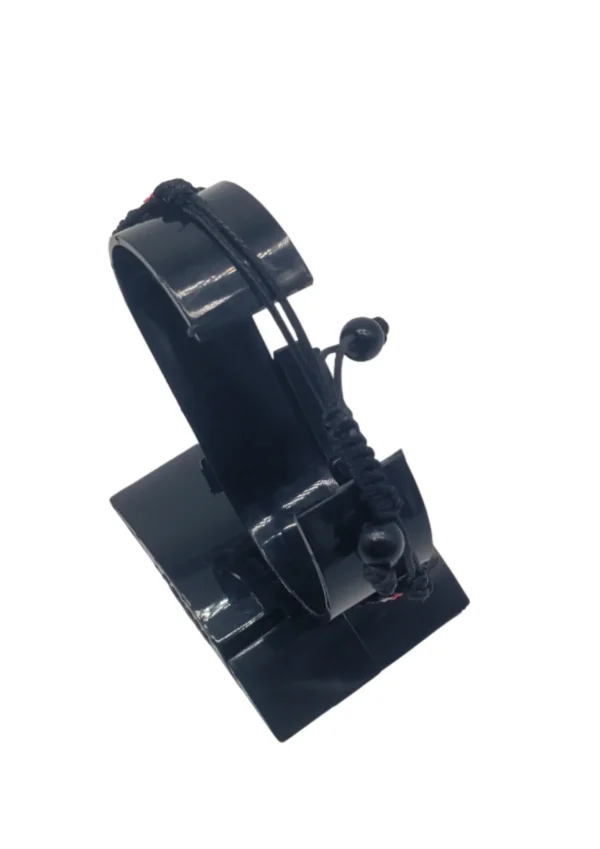 Back view of adjustable Flag Bracelet showing black nylon cord closure.