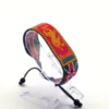 Kenyan Bhutan combo flag bead bracelet with adjustable fit displayed on a Clear stand