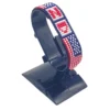 Handcrafted USA flag bracelet made with red and white beads, adjustable beaded wrist accessory, displayed on a black stand.