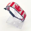 Canada flag bracelet handcrafted in authentic flag colors on Black Stand.