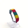 Cameroon flag bracelet handcrafted in authentic flag colors on Clear Stand.