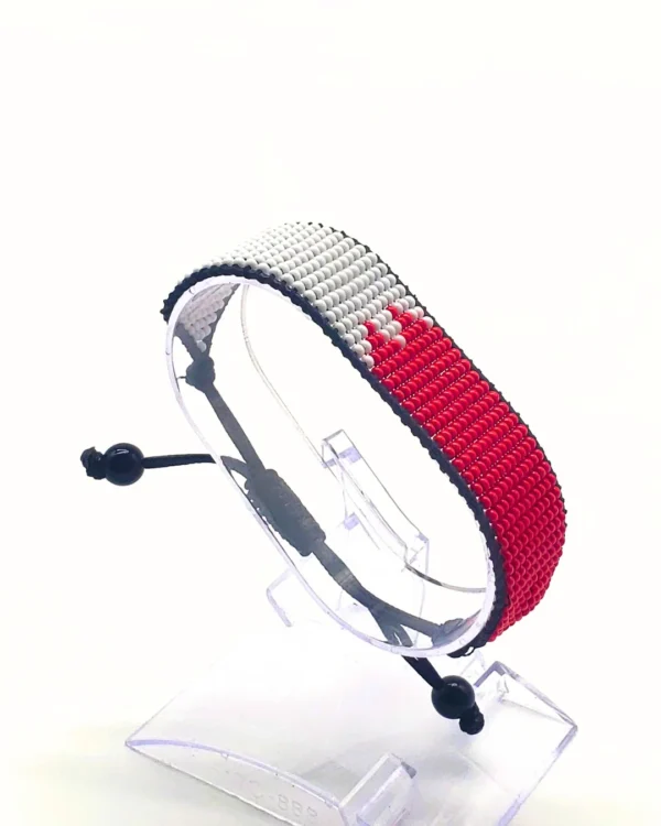 Canada flag bracelet handcrafted in authentic flag colors on Clear Stand.