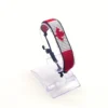 Canada flag bracelet handcrafted in authentic flag colors on Clear Stand.