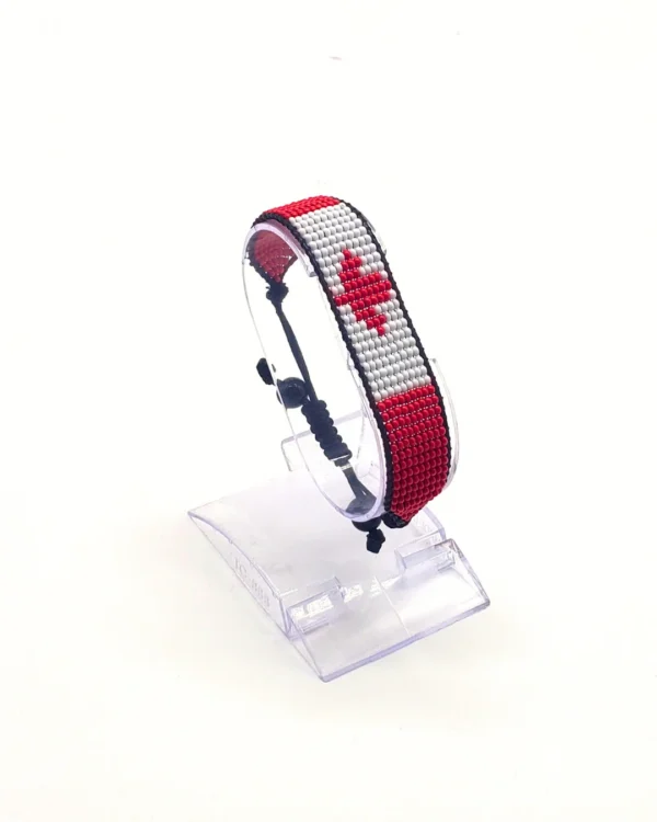 Canada flag bracelet handcrafted in authentic flag colors on Clear Stand.