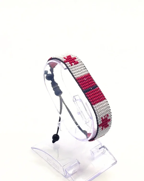 Canada flag bracelet handcrafted in authentic flag colors on Clear Stand.