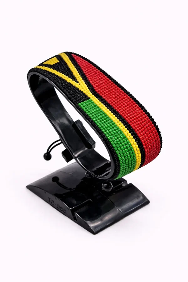 Handcrafted Vanuatu flag bracelet, adjustable beaded wrist accessory, displayed on a black stand.