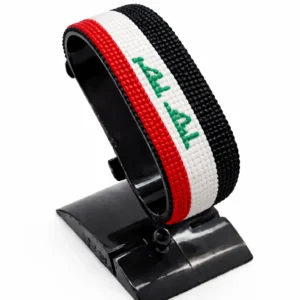 Handcrafted Iraq flag bracelet made with red and white beads, adjustable beaded wrist accessory, displayed on a black stand