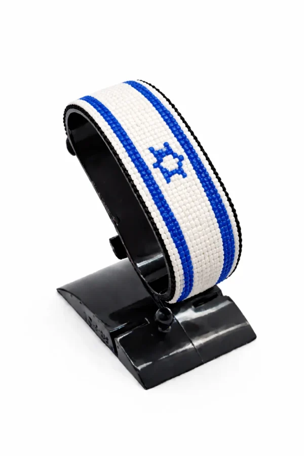 Handcrafted Israel flag bracelet made with red and white beads, adjustable beaded wrist accessory, displayed on a black stand