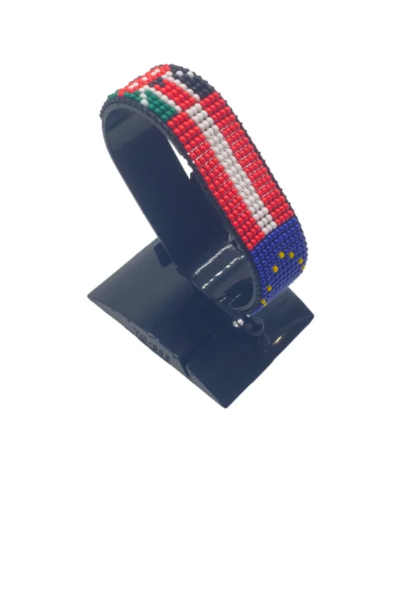 Kenya Euro Austria Flag Bracelet Adjustable made with red and white beads, adjustable beaded wrist accessory, displayed on a black stand.