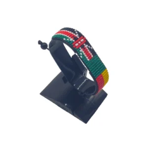 Handcrafted Kenya flag bracelet made with red and white beads, adjustable beaded wrist accessory, displayed on a black stand