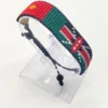 Handcrafted Kenya flag bracelet made with red and white beads, adjustable beaded wrist accessory, displayed on a Clear stand