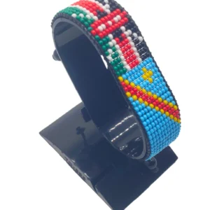 Handcrafted Kenya flag bracelet made with red and white beads, adjustable beaded wrist accessory, displayed on a black stand