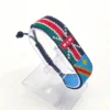 Handcrafted Kenya flag bracelet made with red and white beads, adjustable beaded wrist accessory, displayed on a Clear stand