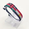 Handcrafted Kenya Egypt flag bracelet made with red and white beads, adjustable beaded wrist accessory, displayed on a Clear stand