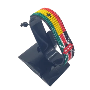Handcrafted Kenya flag bracelet made with red and white beads, adjustable beaded wrist accessory, displayed on a black stand