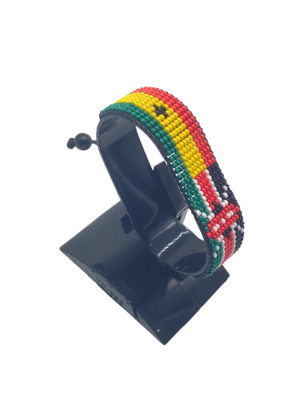 Handcrafted Kenya flag bracelet made with red and white beads, adjustable beaded wrist accessory, displayed on a black stand