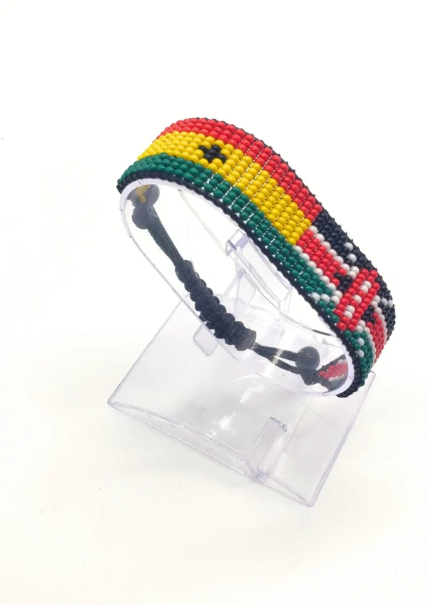 Handcrafted Kenya Egypt flag bracelet made with red and white beads, adjustable beaded wrist accessory, displayed on a Clear stand