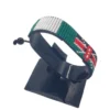 Handcrafted Kenya flag bracelet made with red and white beads, adjustable beaded wrist accessory, displayed on a black stand