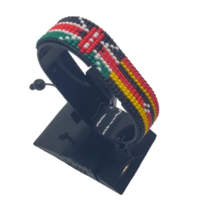 Handcrafted Kenya Uganda flag bracelet made with red and white beads, adjustable beaded wrist accessory, displayed on a black stand
