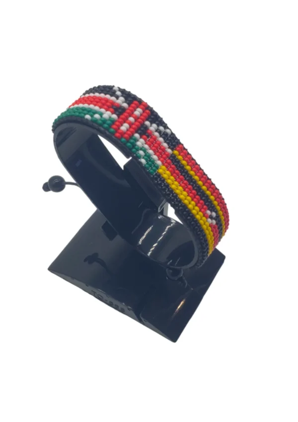 Handcrafted Kenya Uganda flag bracelet made with red and white beads, adjustable beaded wrist accessory, displayed on a black stand