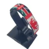 Handcrafted Kenya flag bracelet made with red and white beads, adjustable beaded wrist accessory, displayed on a black stand