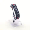 Kenya name flag bead bracelet with adjustable fit displayed on a Clear Stand