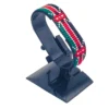 Adjustable handcrafted Kenyan flag bead bracelet on a black cuff display stand