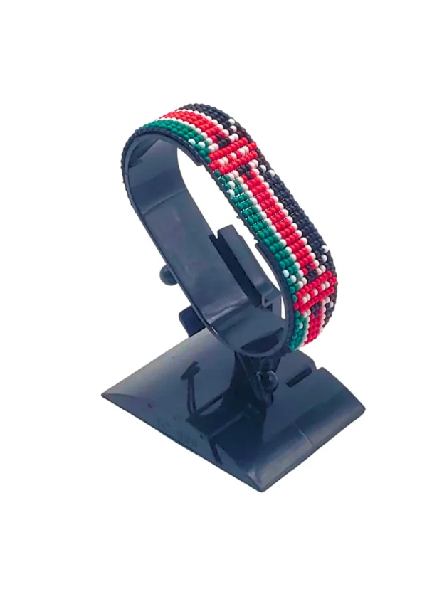 Adjustable handcrafted Kenyan flag bead bracelet on a black cuff display stand