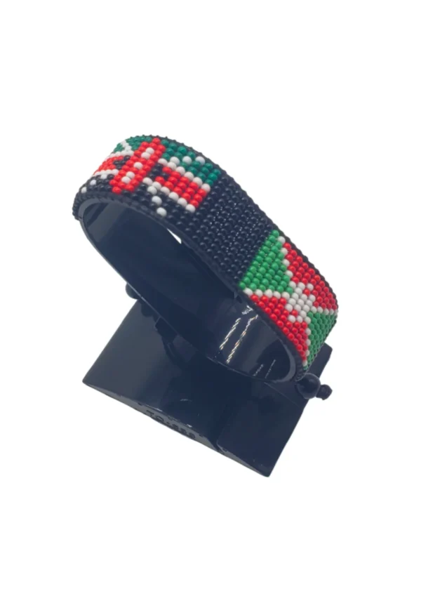 Handcrafted Kenya Burundi flag bracelet made with red and white beads, adjustable beaded wrist accessory, displayed on a black stand
