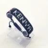 Kenya name flag bead bracelet with adjustable fit displayed on a Clear stand