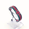 Handcrafted Kenyan flag bead bracelet displayed on a clear stand with adjustable fit