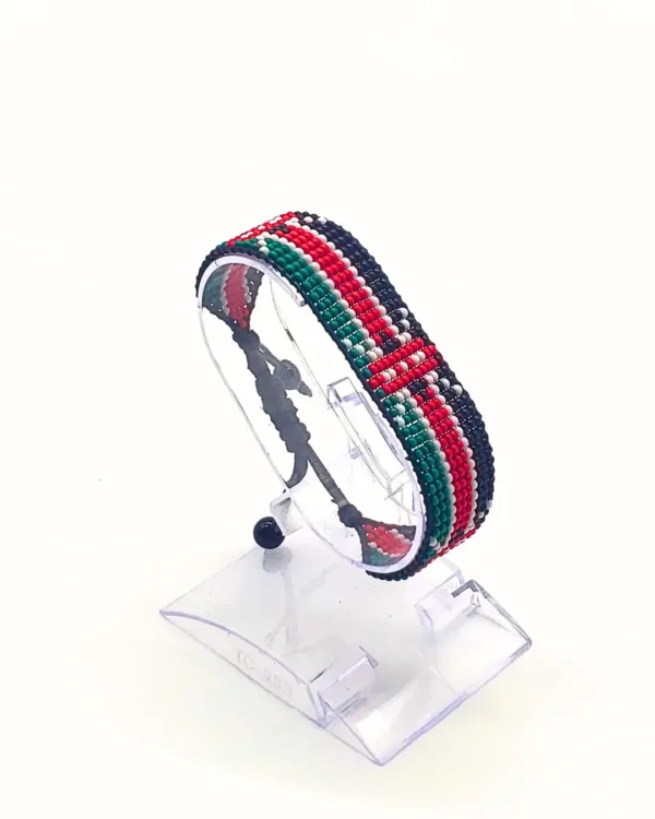 Handcrafted Kenyan flag bead bracelet displayed on a clear stand with adjustable fit