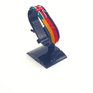 Handcrafted Kenya Germany flag bracelet made with red and white beads, adjustable beaded wrist accessory, displayed on a black stand