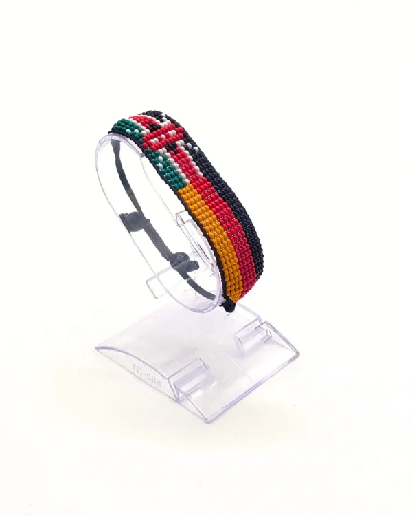 Handcrafted Kenya Germany flag bracelet made with red and white beads, adjustable beaded wrist accessory, displayed on a clear stand