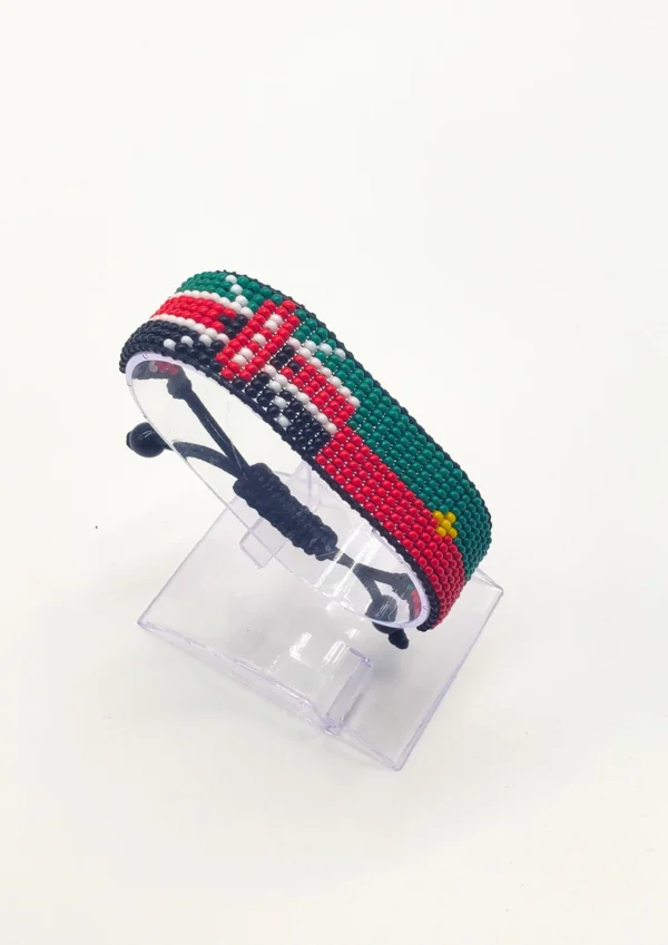 Handcrafted Kenya Morocco flag bracelet made with red and white beads, adjustable beaded wrist accessory, displayed on a clear stand