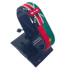 Handcrafted Kenya Morocco flag bracelet made with red and white beads, adjustable beaded wrist accessory, displayed on a black stand