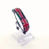Kenyan UK combo flag bead bracelet with adjustable fit displayed on a Clear stand