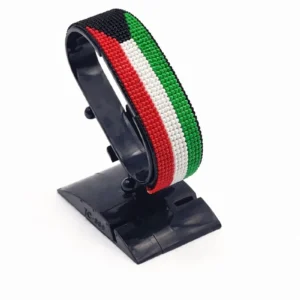 Handcrafted Kuwait flag bracelet made with red and white beads, adjustable beaded wrist accessory, displayed on a black stand