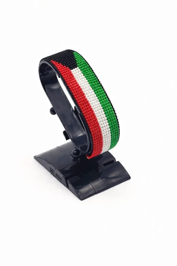 Handcrafted Kuwait flag bracelet made with red and white beads, adjustable beaded wrist accessory, displayed on a black stand