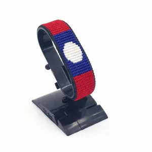 Handcrafted Laos flag bracelet made with red and white beads, adjustable beaded wrist accessory, displayed on a black stand
