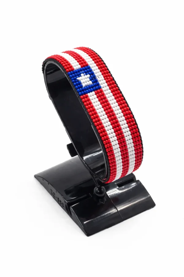Handcrafted Liberia flag bracelet made with red and white beads, adjustable beaded wrist accessory, displayed on a black stand