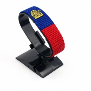 Handcrafted Liechtenstein flag bracelet made with red and white beads, adjustable beaded wrist accessory, displayed on a black stand