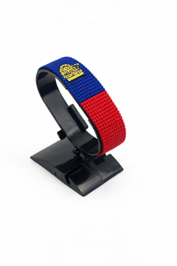 Handcrafted Liechtenstein flag bracelet made with red and white beads, adjustable beaded wrist accessory, displayed on a black stand