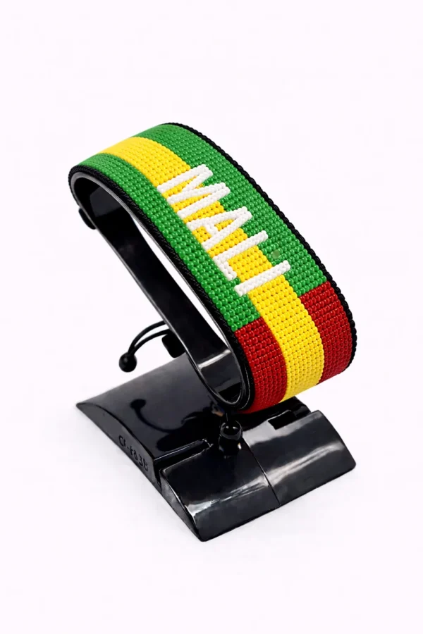 Handcrafted Mali flag bracelet made with red and white beads, adjustable beaded wrist accessory, displayed on a black stand