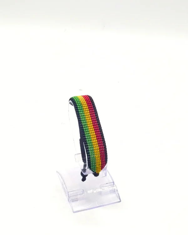 Mozambiqueflag bracelet handcrafted in authentic flag colors on Clear Stand.