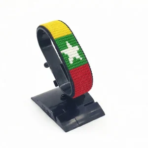 Handcrafted Myanmar flag bracelet made with red and white beads, adjustable beaded wrist accessory, displayed on a black stand